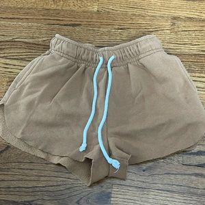 Tan sweat shorts with white tie strings